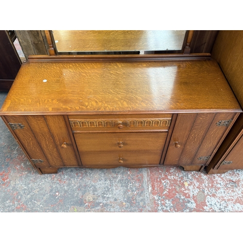 178 - A mid 20th century Austinsuite carved oak four piece bedroom suite comprising two double wardrobes, ... 