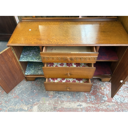 178 - A mid 20th century Austinsuite carved oak four piece bedroom suite comprising two double wardrobes, ... 