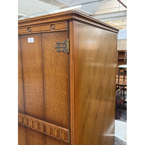 178 - A mid 20th century Austinsuite carved oak four piece bedroom suite comprising two double wardrobes, ... 