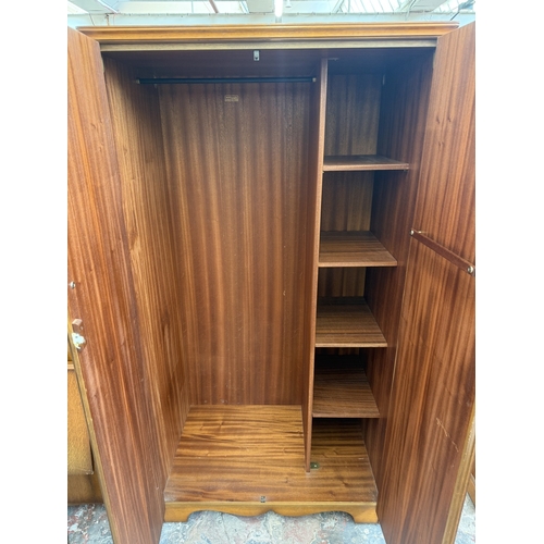 178 - A mid 20th century Austinsuite carved oak four piece bedroom suite comprising two double wardrobes, ... 