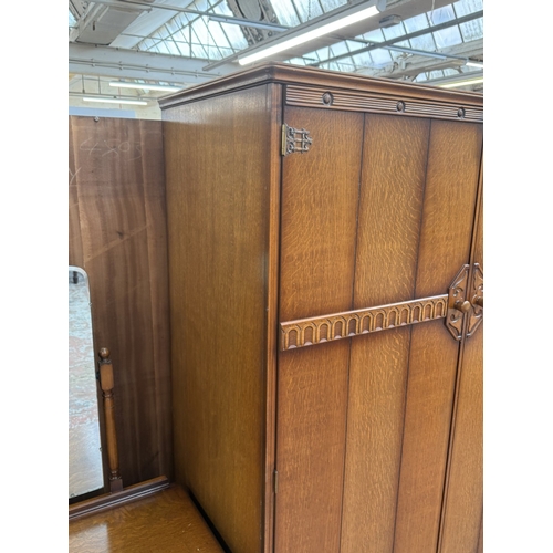 178 - A mid 20th century Austinsuite carved oak four piece bedroom suite comprising two double wardrobes, ... 