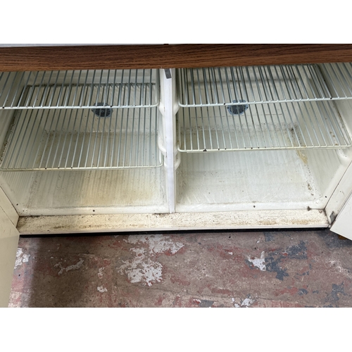 74 - A mid 20th century Eastham white painted and blue laminate kitchen cabinet - approx. 152cm high x 10... 