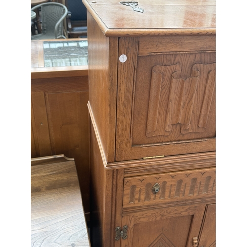 96 - A Jaycee carved oak linenfold cocktail cabinet - approx. 124cm high x 75cm wide x 43cm deep