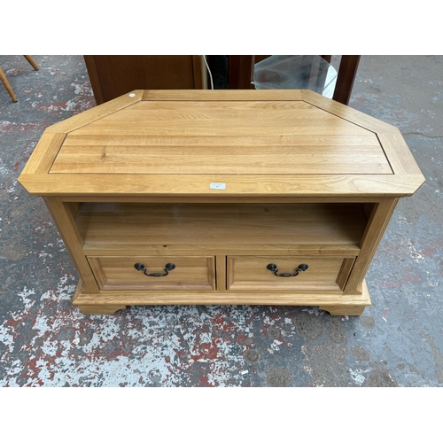 97 - A JB Global oak corner TV stand - approx. 61cm high x 102cm wide x 50cm deep