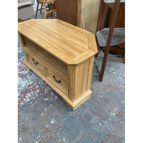 97 - A JB Global oak corner TV stand - approx. 61cm high x 102cm wide x 50cm deep
