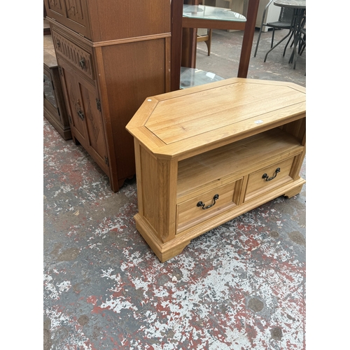97 - A JB Global oak corner TV stand - approx. 61cm high x 102cm wide x 50cm deep