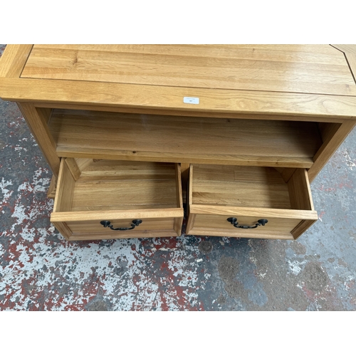 97 - A JB Global oak corner TV stand - approx. 61cm high x 102cm wide x 50cm deep