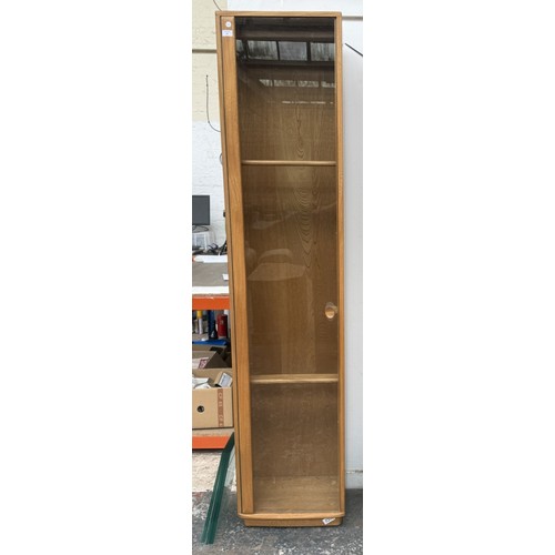 79 - An Ercol Windsor blonde elm and ash narrow display cabinet with six glass shelves - approx. 213cm hi... 