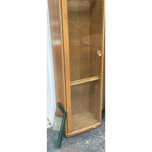 79 - An Ercol Windsor blonde elm and ash narrow display cabinet with six glass shelves - approx. 213cm hi... 