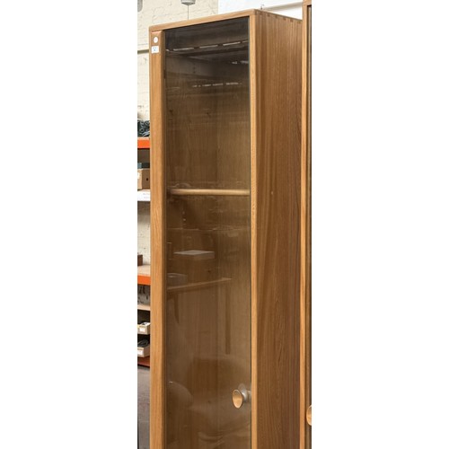 79 - An Ercol Windsor blonde elm and ash narrow display cabinet with six glass shelves - approx. 213cm hi... 