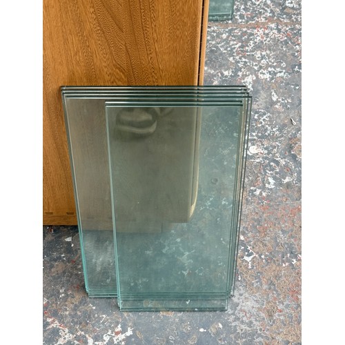 79 - An Ercol Windsor blonde elm and ash narrow display cabinet with six glass shelves - approx. 213cm hi... 