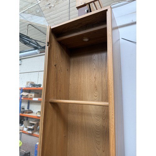 79 - An Ercol Windsor blonde elm and ash narrow display cabinet with six glass shelves - approx. 213cm hi... 