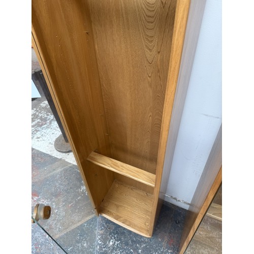 79 - An Ercol Windsor blonde elm and ash narrow display cabinet with six glass shelves - approx. 213cm hi... 