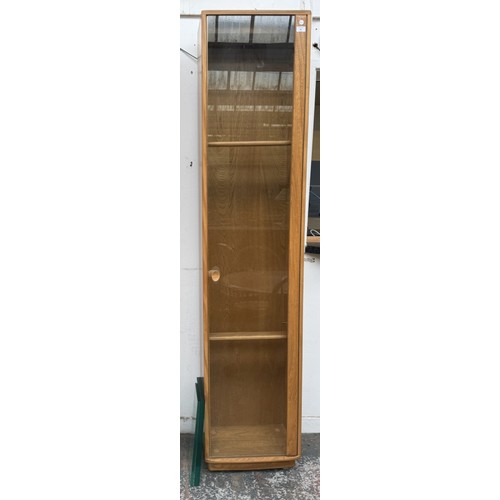 80 - An Ercol Windsor blonde elm and ash narrow display cabinet with six glass shelves - approx. 213cm hi... 
