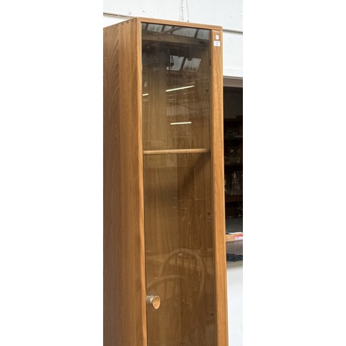 80 - An Ercol Windsor blonde elm and ash narrow display cabinet with six glass shelves - approx. 213cm hi... 