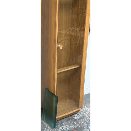 80 - An Ercol Windsor blonde elm and ash narrow display cabinet with six glass shelves - approx. 213cm hi... 