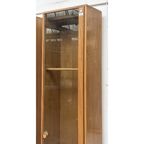 80 - An Ercol Windsor blonde elm and ash narrow display cabinet with six glass shelves - approx. 213cm hi... 