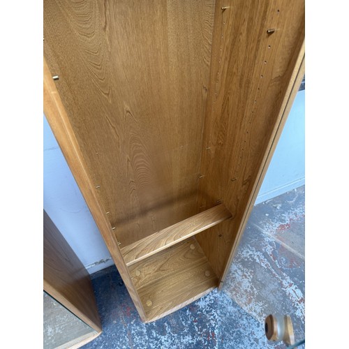 80 - An Ercol Windsor blonde elm and ash narrow display cabinet with six glass shelves - approx. 213cm hi... 