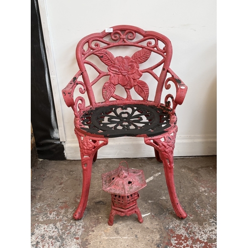 209A - Two red painted cast iron garden items, one Oriental style pagoda lantern - approx. 27cm high and on... 