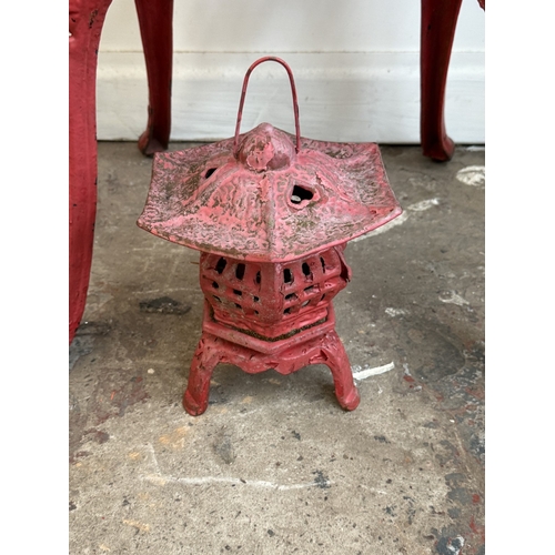 209A - Two red painted cast iron garden items, one Oriental style pagoda lantern - approx. 27cm high and on... 