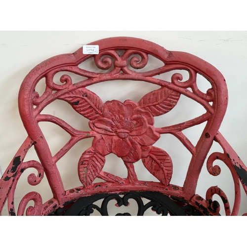 209A - Two red painted cast iron garden items, one Oriental style pagoda lantern - approx. 27cm high and on... 