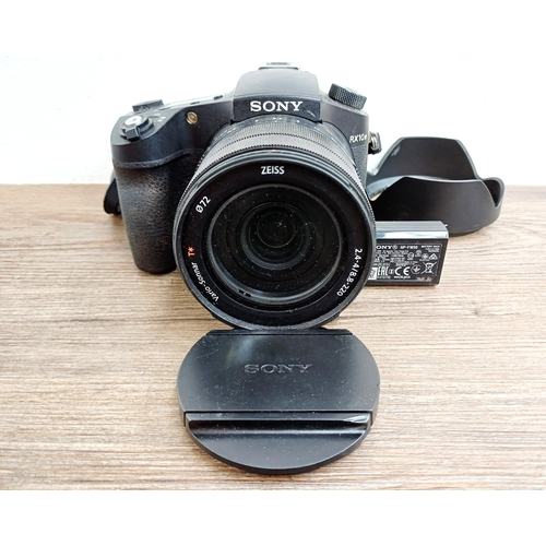 A Sony RX10 IV 20.1mp 1" Stacked-CMOS sensor 24fps burst rate digital bridge camera with Zeiss Vario-Sonnar T* 1:2.4-4 8.8-220mm lens (24-600mm=35mm equivalent) with shade, cap, strap and two batteries