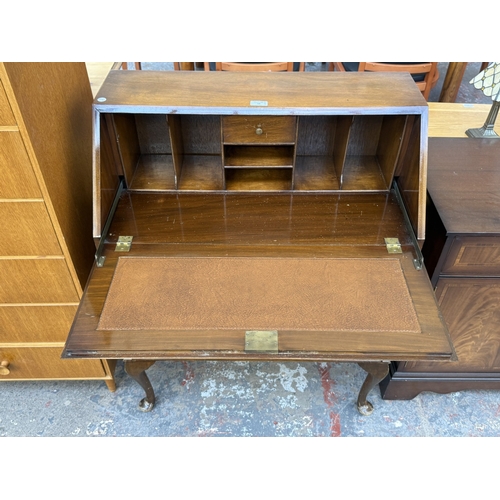 16 - A Georgian style walnut and mahogany bureau on cabriole supports - approx. 101cm high x 77cm wide x ... 