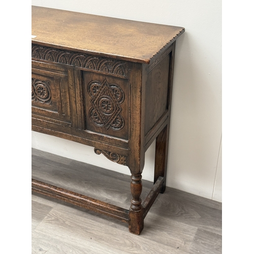 10 - An early/mid 20th century Jacobean style carved oak side cabinet, bearing 'Hunters Furnishers Derby'... 