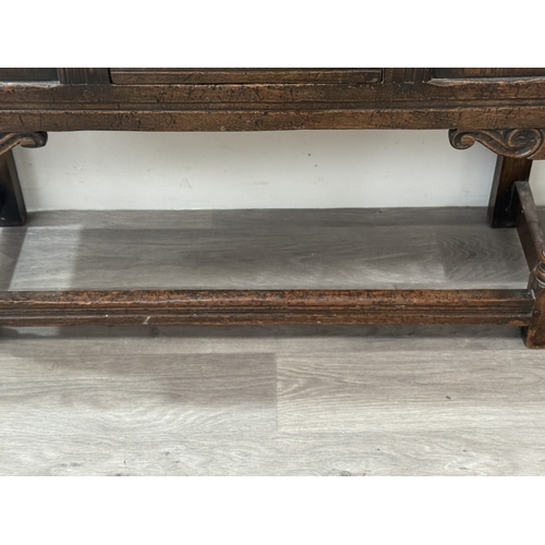 10 - An early/mid 20th century Jacobean style carved oak side cabinet, bearing 'Hunters Furnishers Derby'... 
