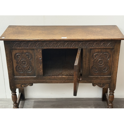 10 - An early/mid 20th century Jacobean style carved oak side cabinet, bearing 'Hunters Furnishers Derby'... 