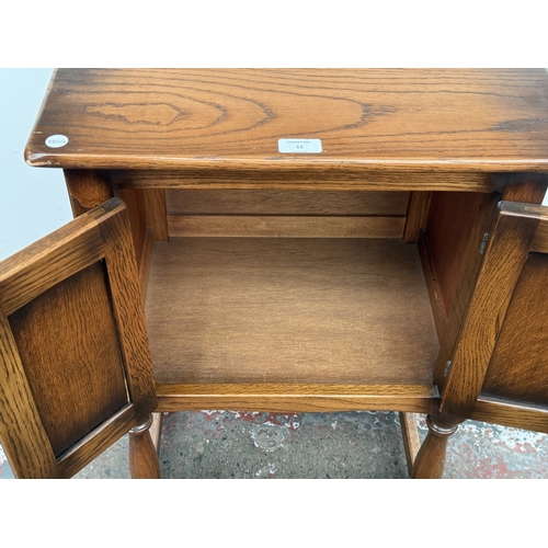 11 - A mid/late 20th century carved oak linenfold two door cabinet - approx. 72cm high x 51cm wide x 38cm... 
