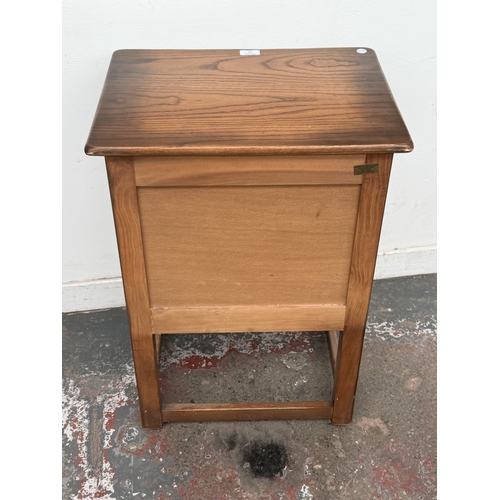 11 - A mid/late 20th century carved oak linenfold two door cabinet - approx. 72cm high x 51cm wide x 38cm... 