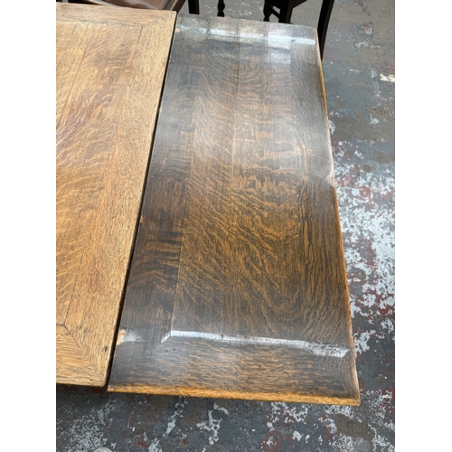 12 - An early 20th century oak draw leaf barley twist dining table and four oak and cane back barley twis... 