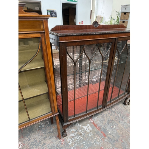 15 - An early 20th century Georgian style carved mahogany bow fronted display cabinet on ball and claw su... 