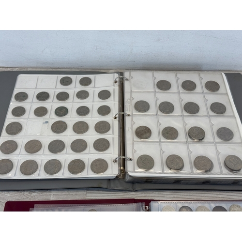 Two coin albums containing a collection of world coins; silver examples ...