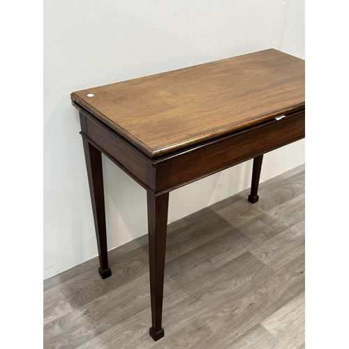 A George III mahogany fold over card table with green baize lined top ...