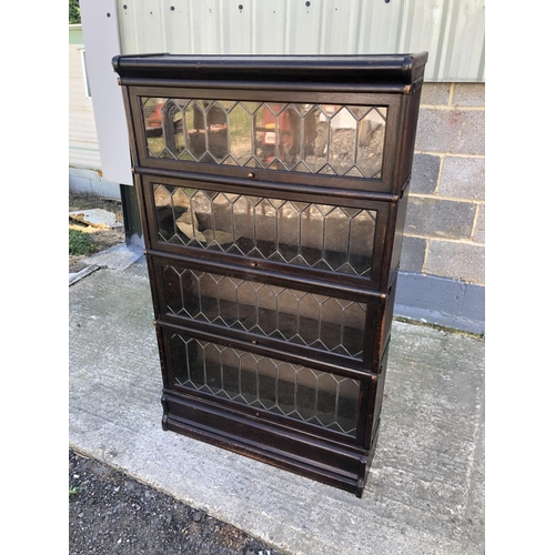 132 - A 'Globe Wernicke' Style sectional oak bookcase with four sections each with leaded glass up and ove... 