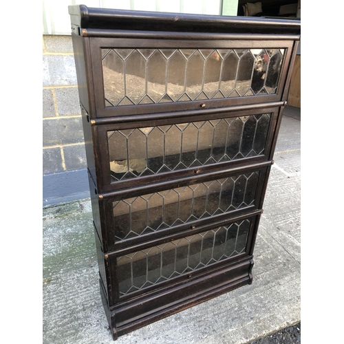 132 - A 'Globe Wernicke' Style sectional oak bookcase with four sections each with leaded glass up and ove... 