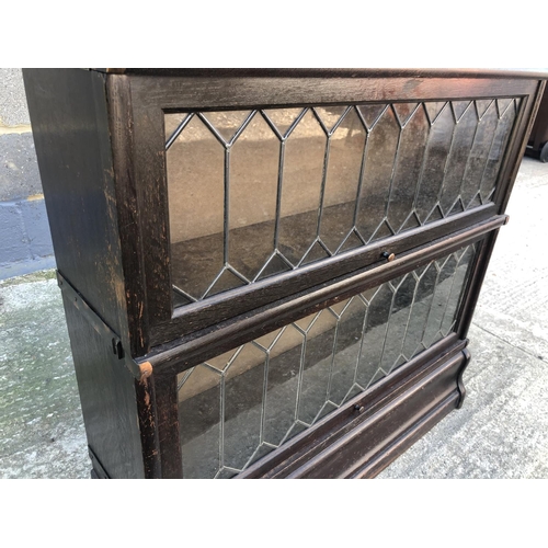 132 - A 'Globe Wernicke' Style sectional oak bookcase with four sections each with leaded glass up and ove... 