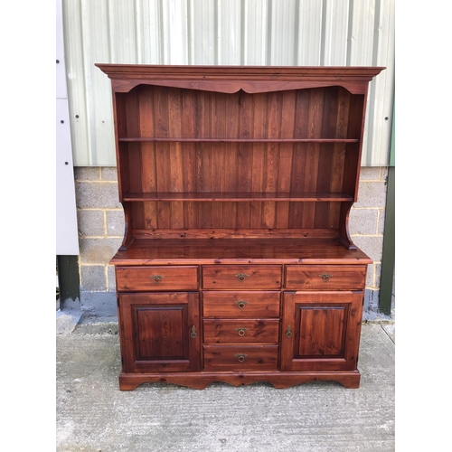 148 - A Modern Stained Pine dresser shelved top section, over three drawers and cupboard base 152cm x 45cm... 