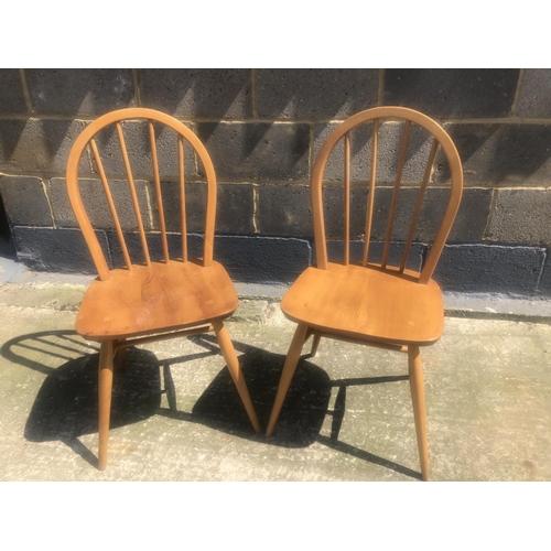 149 - A pair of ercol stick back dining chairs