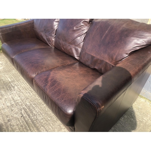 180 - A modern brown leather three seater sofa 200cm x 80cm x 75cm