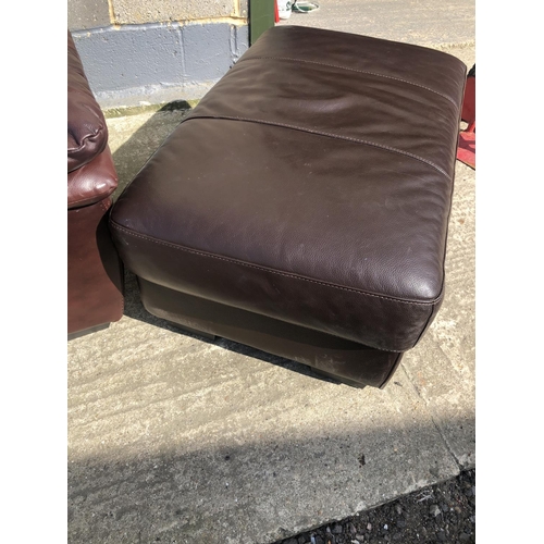 181 - A modern brown leather two seater sofa together with a brown leather footstool