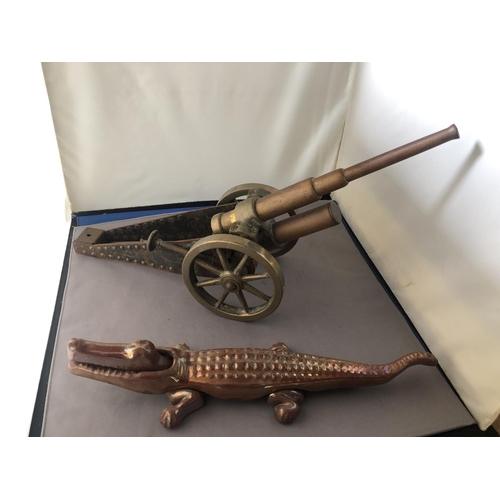 300 - A model brass table cannon together with a novelty crocodile nut cracker