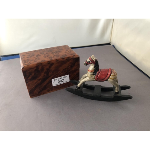 302 - A Thuya wood card box containing two sets playing cards together with a small rocking horse toy