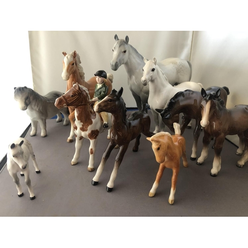 311 - A collection of ten Beswick horses comprising of 8 larger and two smaller