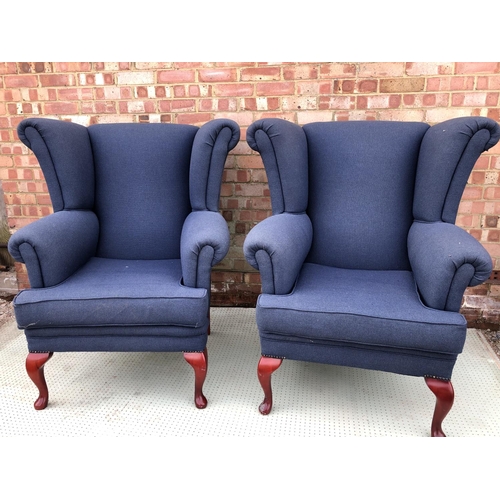 46 - A large pair of modern blue upholstered wing armchairs