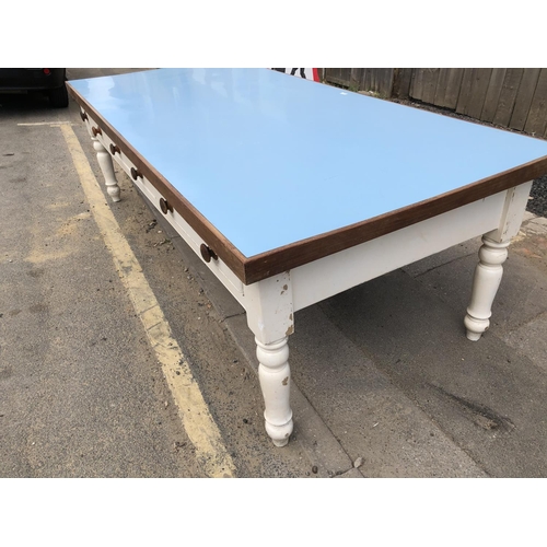 54 - A huge painted pine country house kitchen table, Formica top, 3 drawers to each side on solid pine l... 