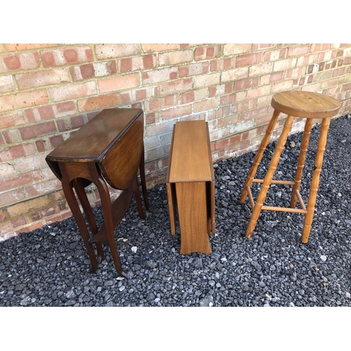 94 - A mahogany Sutherland table together with a teak Sutherland table and a pine stool