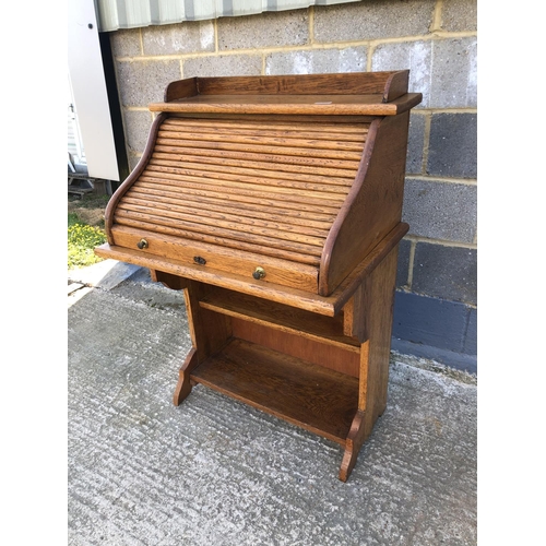 1 - A small oak roll top desk 75x56x114cm